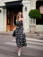 a lady wears a floral printed maxi strap dress with high heels